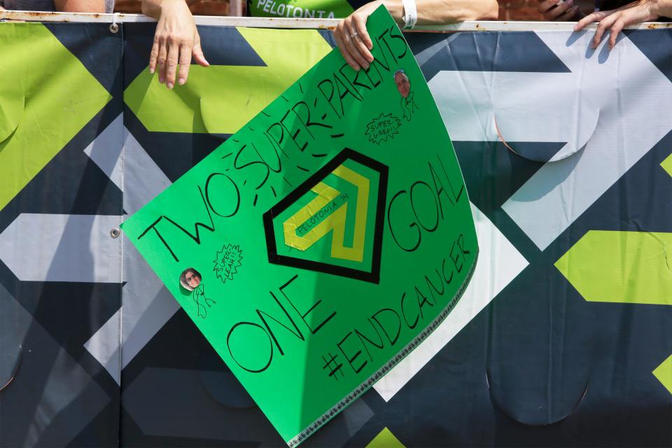 Family and friends spectate at the 180 mile finish line at Market Square in New Albany, Ohio, with thank you signs to support riders in the 6th Pelotonia ride in 2014.