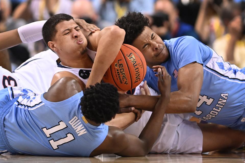 Virginia forward Kadin Shedrick, center, fights for a loose ball against North Carolina in the ACC Tournament in March. Shedrick joined the Texas program  in the offseason and hopes to become the latest Longhorn big man to get drafted into the NBA.