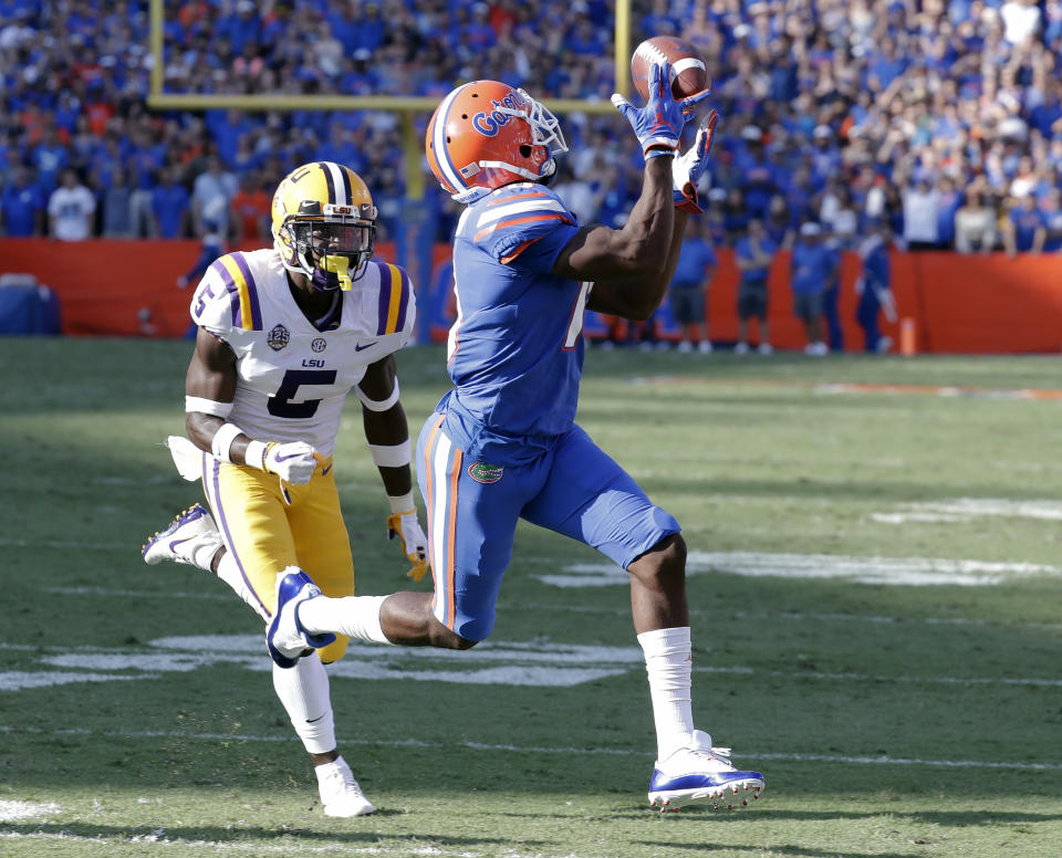 Florida wide receiver Josh Hammond, right, catches a 35-yard pass in front of LSU cornerback Kary Vincent Jr., left, to set up a Florida touchdown in the first half of an NCAA college football game, Saturday, Oct. 6, 2018, in Gainesville, Fla. (AP Photo/John Raoux)