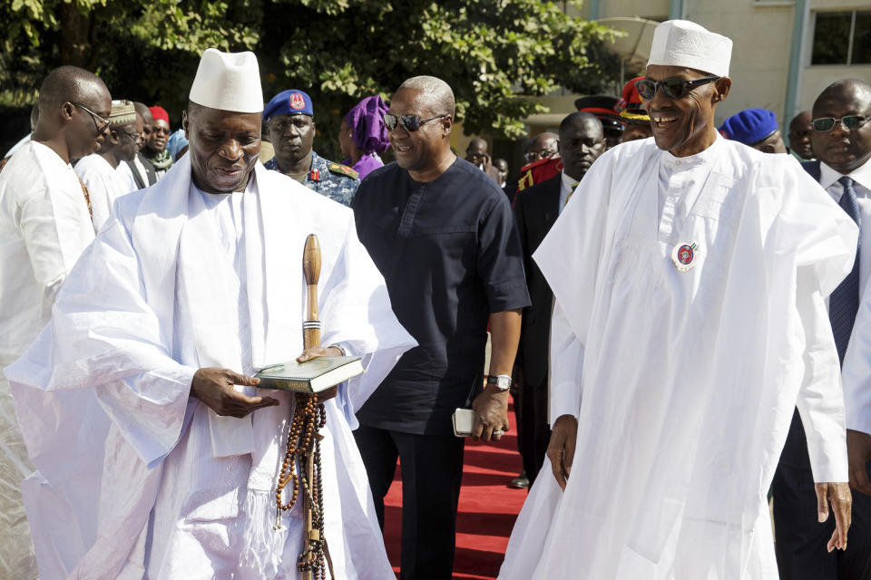 In this photo released by the Nigeria State House, Gambia President, Yahya Jammeh, left, walk along side with Nigeria President Muhammadu Buhari, upon arrival in Banjul Gambia, Friday Jan.13, 2017. Nigeria's president was leading a regional delegation to Gambia in a last-ditch attempt Friday to persuade its longtime leader to step down and allow his rival's inauguration next week, while fears grow that the impasse could turn violent. (Bayo Omoboriowo/Nigeria State House via AP)