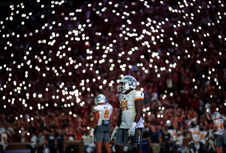 Fans light up the stadium with their phones as Kent prepares for a kickoff during the college football game between the University of Oklahoma and the Kent State Golden Flashes at Gaylord Family Oklahoma Memorial Stadium in Norman, Okla., Saturday, 10 September, 2022. 
