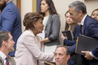 Chairwoman Rep. Maxine Waters, D-Calif., left, and David Marcus, CEO of Facebook's Calibra digital wallet service, speak during a hearing break while Marcus appears before a House Financial Services Committee hearing on Facebook's proposed cryptocurrency on Capitol Hill in Washington, Wednesday, July 17, 2019. (AP Photo/Andrew Harnik)