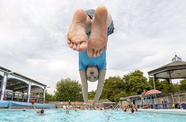 A child in the hot weather at Hathersage open air swimming pool at Hope Valley, near Sheffield