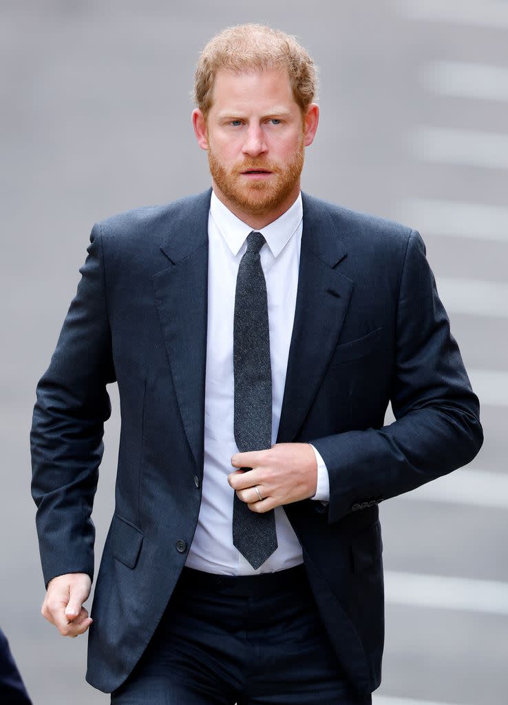 Prince Harry walks down road