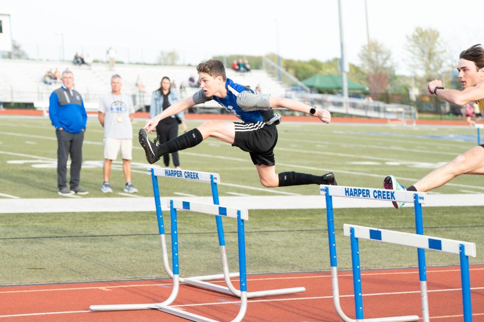 Harper Creek's Joey DeRose competes in the mixed hurdles relay race during the invitational meet at Harper Creek High School on Friday, May 5, 2023.