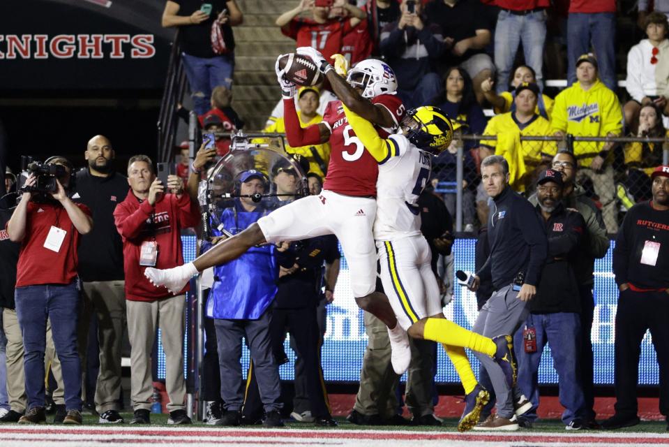 Sean Ryan (5) of the Rutgers Scarlet Knights makes a catch in the end zone for a touchdown as DJ Turner (5) of the Michigan Wolverines defends during the second quarter of a game at SHI Stadium on November 5, 2022 in Piscataway, New Jersey.