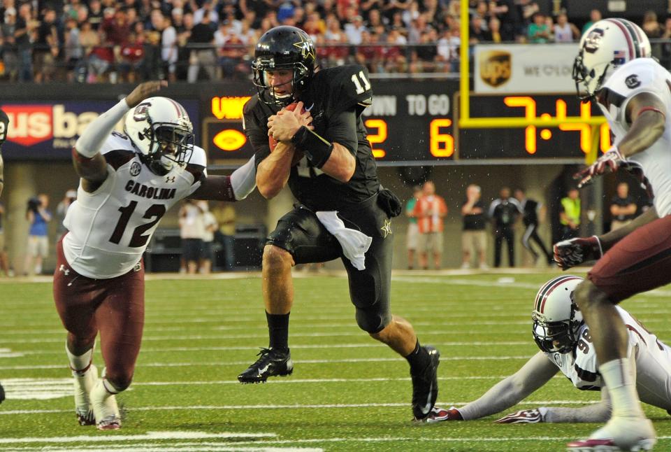 Quarterback Jordan Rodgers #11 of the Vanderbilt Commodores tries to avoid Brison Williams #12 of the South Carolina Gamecocks at Vanderbilt Stadium on August 30, 2012 in Nashville, Tennessee. (Photo by Frederick Breedon/Getty Images)