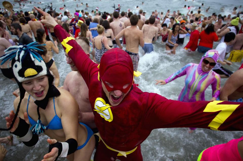 Participants run into English Bay during the 94th annual New Year's Day Polar Bear Swim in Vancouver