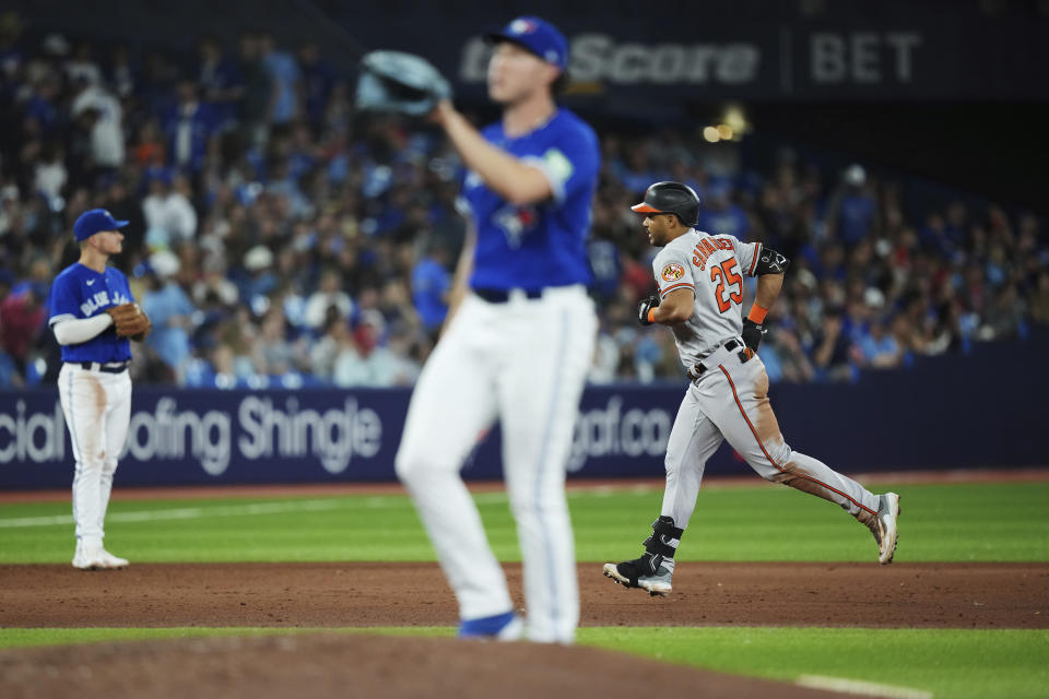 Baltimore Orioles' Anthony Santander (25) rounds the bases after hitting a grand slam against Toronto Blue Jays relief pitcher Nate Pearson, center, during the eighth inning of a baseball game in Toronto on Tuesday, Aug. 1, 2023. (Nathan Denette/The Canadian Press via AP)