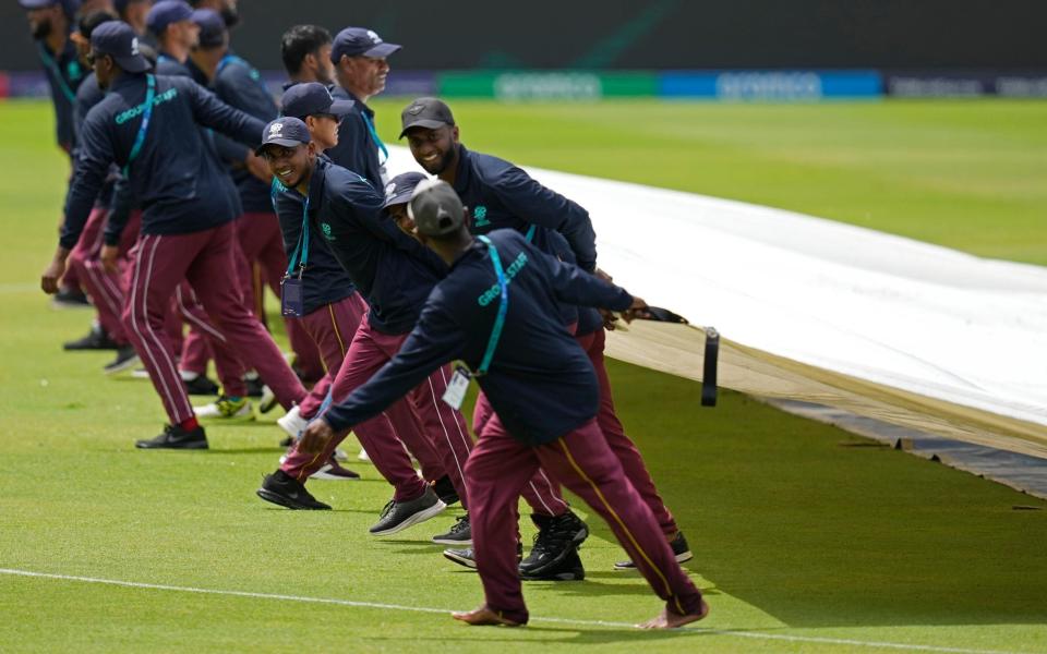 The groundsmen pull the covers off