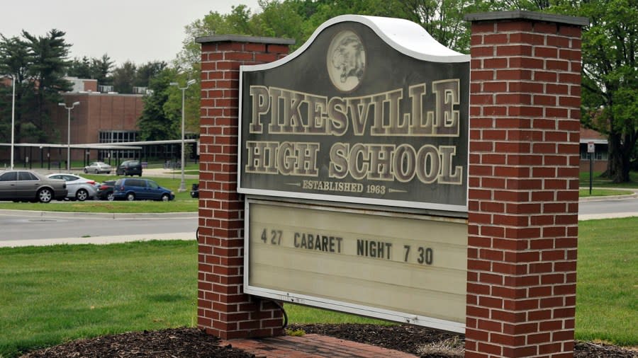 This undated photo shows the Pikesville High School sign on the school property. Baltimore County Police Chief Robert McCullough and other local officials speak at a news conference in Towson, Maryland, on Thursday, April 25, 2024. The officials discussed the arrest of a high school athletic director on charges ​that he used artificial intelligence to impersonate a principal on an audio recording that included racist and antisemitic comments. (Lloyd Fox/The Baltimore Sun via AP)