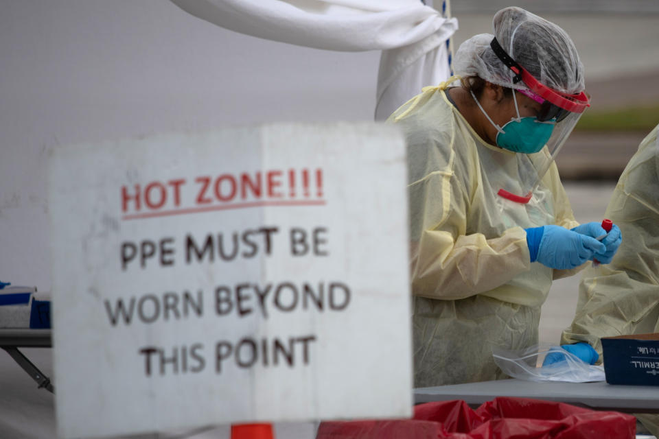 A healthcare worker prepares specimen collection tubes at a coronavirus disease (COVID-19) drive-thru testing location in Houston, Texas on November 20, 2020.   (Adrees Latif/Reuters)