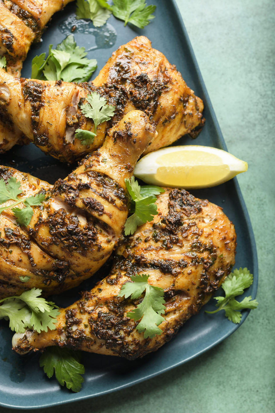 This image released by Milk Street shows a recipe for Moroccan Inspired Roasted Spiced Chicken. (Milk Street via AP)