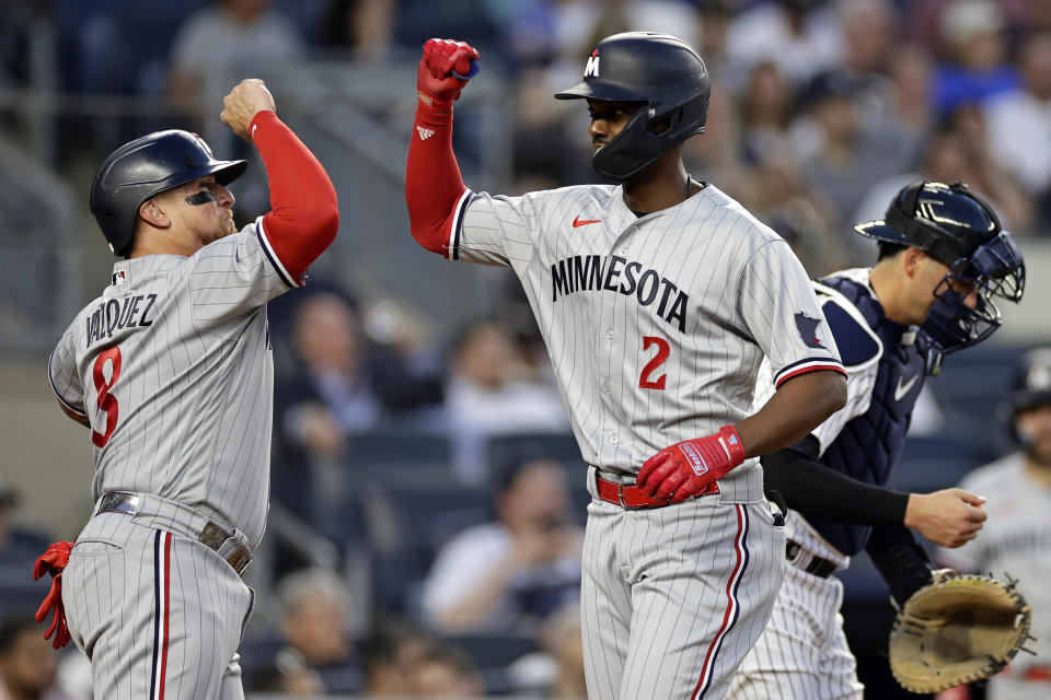 Minnesota Twins' Michael A. Taylor celebrates his two-run home run with Christian Vazquez (8), next to New York Yankees catcher Kyle Higashioka during the first inning of a baseball game Thursday, April 13, 2023, in New York. (AP Photo/Adam Hunger)