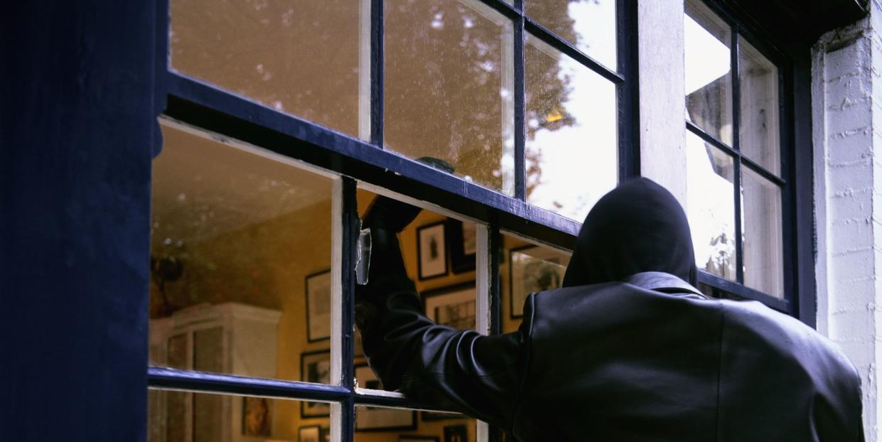 burglar smashing through window