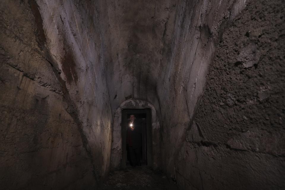 Bukurosh Onuzi, a tourist expert in charge of the museum project, shows the underground tunnels beneath the city of Kukes, about 150 kilometers (90 miles) north of Tirana, Albania, Wednesday, March 15, 2023. A new underground museum of tunnels built during the former communist regime to shelter residents in case of a war will serve Kukes, Albania’s poorest district, to attract tourists. (AP Photo/Franc Zhurda)