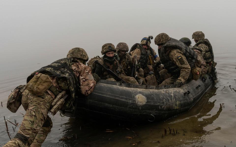 A group of Ukrainian marines sail from the riverbank of Dnipro at the frontline near Kherson, Ukraine