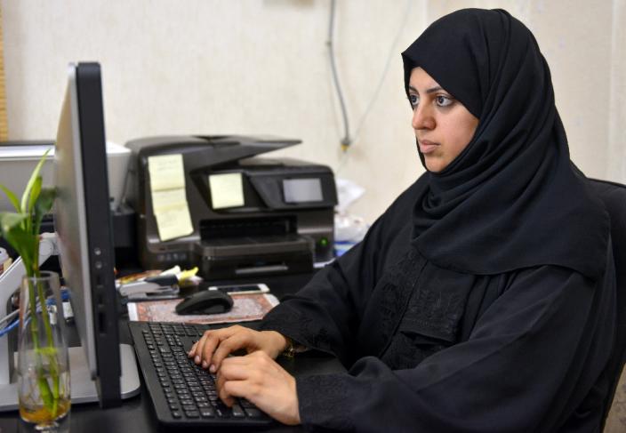 Nassima al-Sadah, a candidate in the municipal council election in the Gulf coast city of Qatif, works at her office on November 26, 2015 (AFP Photo/)