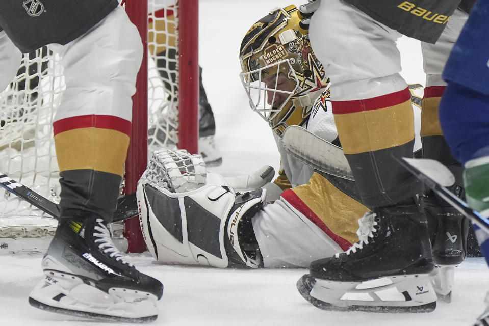 Vegas Golden Knights goalie Adin Hill covers the puck to get a whistle during the first period of the team's NHL hockey game against the Vancouver Canucks on Thursday, Nov 30, 2023, in Vancouver, British Columbia. (Darryl Dyck/The Canadian Press via AP)