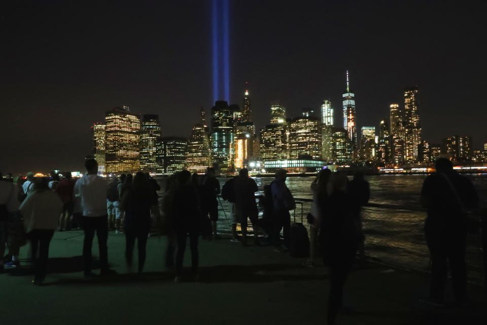<p>People take photos of the Tribute in Light from Brooklyn Bridge Park on Sept. 11, 2017. (Gordon Donovan/Yahoo News) </p>