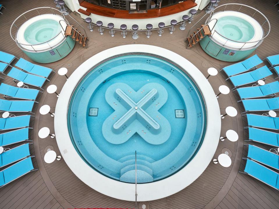 a pool surrounded by lounge chairs