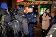 Police officers hold back members of media who try to interview delegation of the North Korea as they leave the restaurant Saaga in Helsinki, Finland March 19, 2018. Lehtikuva/Jussi Nukari via REUTERS