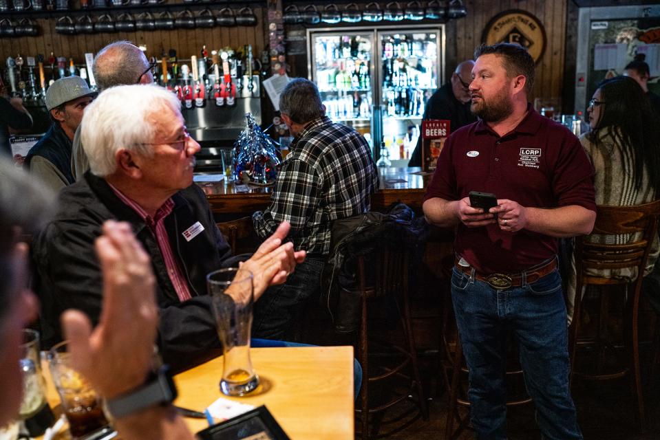 Ron Weinberg, chairman of The Larimer County Republican Party, announces election results at Old Chicago during a watch party in Fort Collins, Colo., on Tuesday, Nov. 8, 2022.