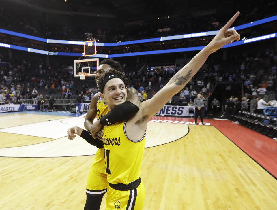 <p>UMBC’s K.J. Maura (11) and Jourdan Grant celebrate the team’s 74-54 win over Virginia in a first-round game in the NCAA men’s college basketball tournament in Charlotte, N.C., Friday, March 16, 2018. (AP Photo/Gerry Broome) </p>