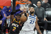 Phoenix Suns forward Josh Okogie (2) dunks against Minnesota Timberwolves center Rudy Gobert (27) during the second half of Game 4 of an NBA basketball first-round playoff series Sunday, April 28, 2024, in Phoenix. The Timberwolves won 122-116, taking the series 4-0. (AP Photo/Ross D. Franklin)