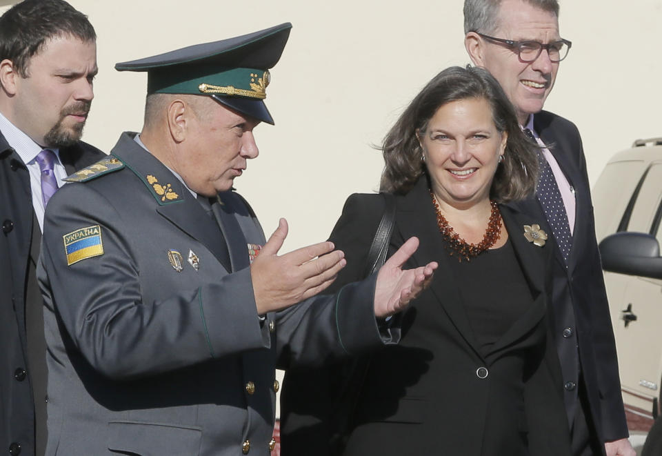 FILE - In this Oct. 8, 2014, file photo, Assistant Secretary for European and Eurasian Affairs Victoria Nuland talks with a Ukrainian border guard general during her visit to the State Border Guard Service in Kyiv, Ukraine. When Secretary of State Antony Blinken travels to Ukraine he’ll be carrying a tough anti-graft message and strong U.S. backing for the country’s response to Russian aggression. He’ll also be bringing along a familiar face in the Washington-Moscow tug-of-war over Ukraine: Victoria Nuland. The mere presence in Kyiv of Nuland, now the No. 3 State Department official, is likely to irritate Russia. (AP Photo/Efrem Lukatsky, File)