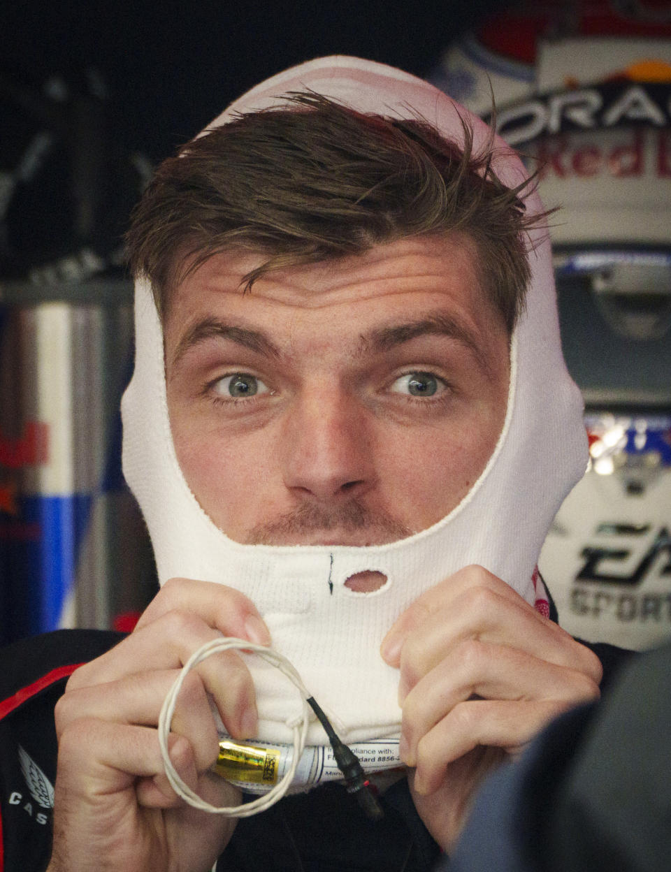 Red Bull Racing driver Max Verstappen of the Netherlands slips on his balaclava as he gets ready to hit the track during practice for the Formula 1 Canadian Grand Prix auto race Friday, June 7, 2024, in Montreal. (Paul Chiasson/The Canadian Press via AP)