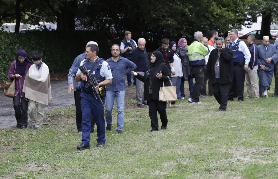 Police escort witnesses away from a mosque in central Christchurch after a mass shooting in New Zealand on March 15, 2019.&nbsp;