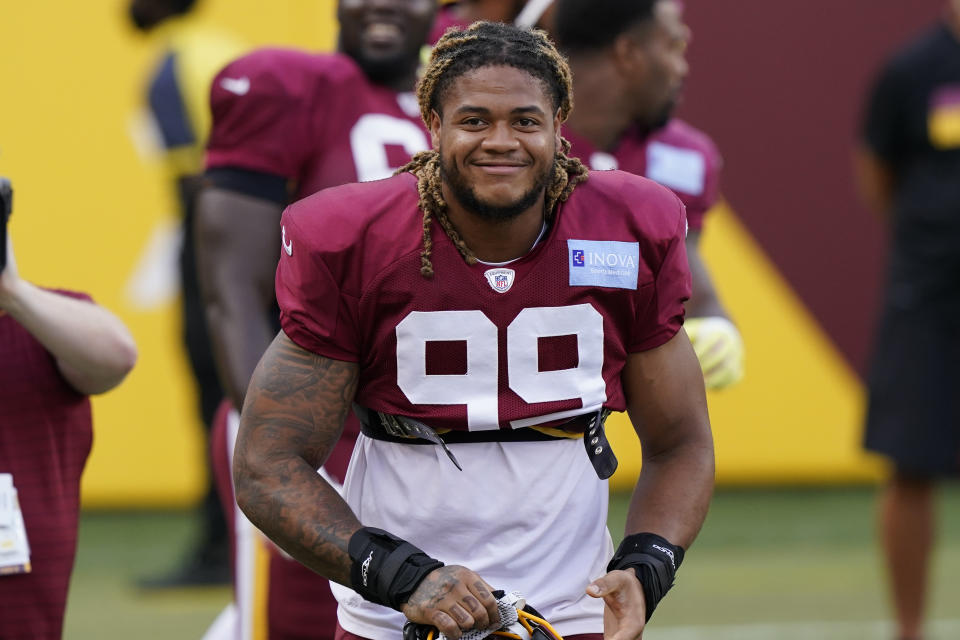 Washington Football Team defensive end Chase Young smiles during the NFL football team's practice Friday, Aug. 6, 2021, in Landover, Md. (AP Photo/Alex Brandon)