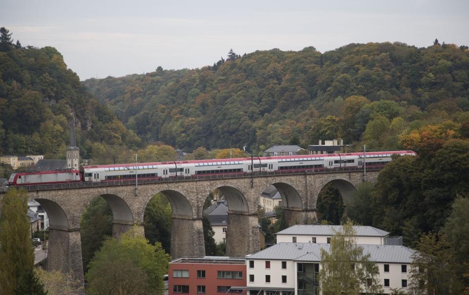 FILE - In this Oct. 19, 2013 file photo, a train passes over a stone bridge in Luxembourg. Luxembourg on Monday, Feb. 8, 2021 denied claims, made in various international media outlets, that Luxembourg is still a massive tax haven despite European Union legislation to clamp down on it. (AP Photo/Virginia Mayo, File)