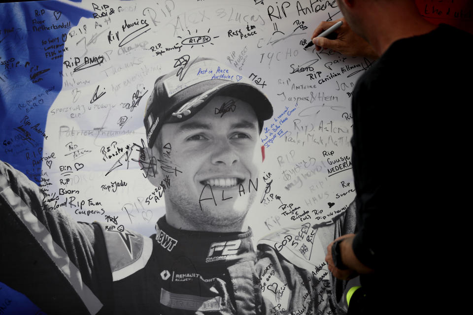 A man signs a remembrance board for Formula 2 driver Anthoine Hubert at the Belgian Formula One Grand Prix circuit in Spa-Francorchamps, Belgium, Sunday, Sept. 1, 2019. The 22-year-old Hubert died Saturday following an estimated 160 mph (257 kph) collision on Lap 2 at the high-speed Spa-Francorchamps track, which earlier Saturday saw qualifying for Sunday's Formula One race. (AP Photo/Francisco Seco)