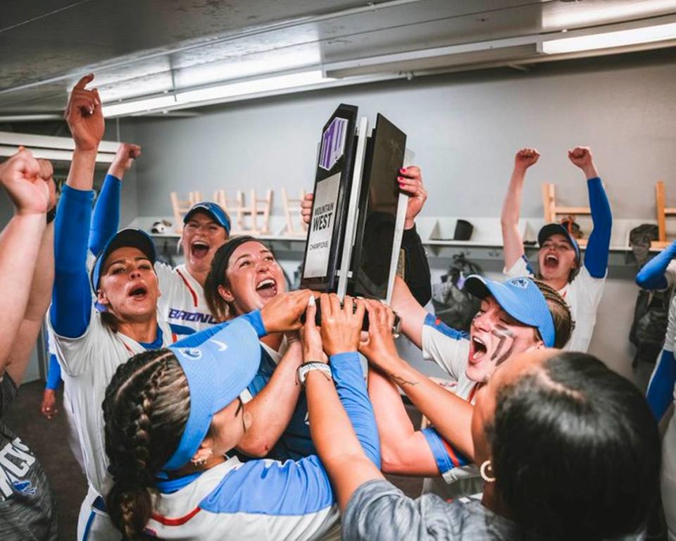 The Boise State softball team celebrates with the regular season Mountain West trophy after a 3-0 win at Fresno State on Friday. Boise State Athletics