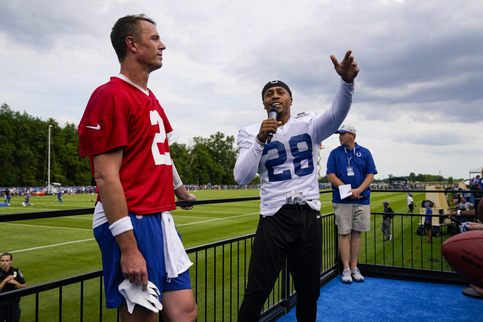 Indianapolis Colts running back Jonathan Taylor and quarterback Matt Ryan address the crowd during practice at the NFL team's football training camp in Westfield, Ind., Saturday, July 30, 2022. (AP Photo/Michael Conroy)