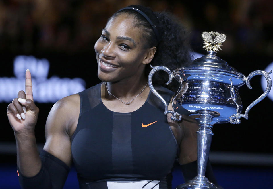 FILE - In this Jan. 28, 2017, file photo, Serena Williams holds up a finger and her trophy after defeating her sister, Venus, in the women's singles final at the Australian Open tennis championships in Melbourne, Australia. (AP Photo/Aaron Favila, File)