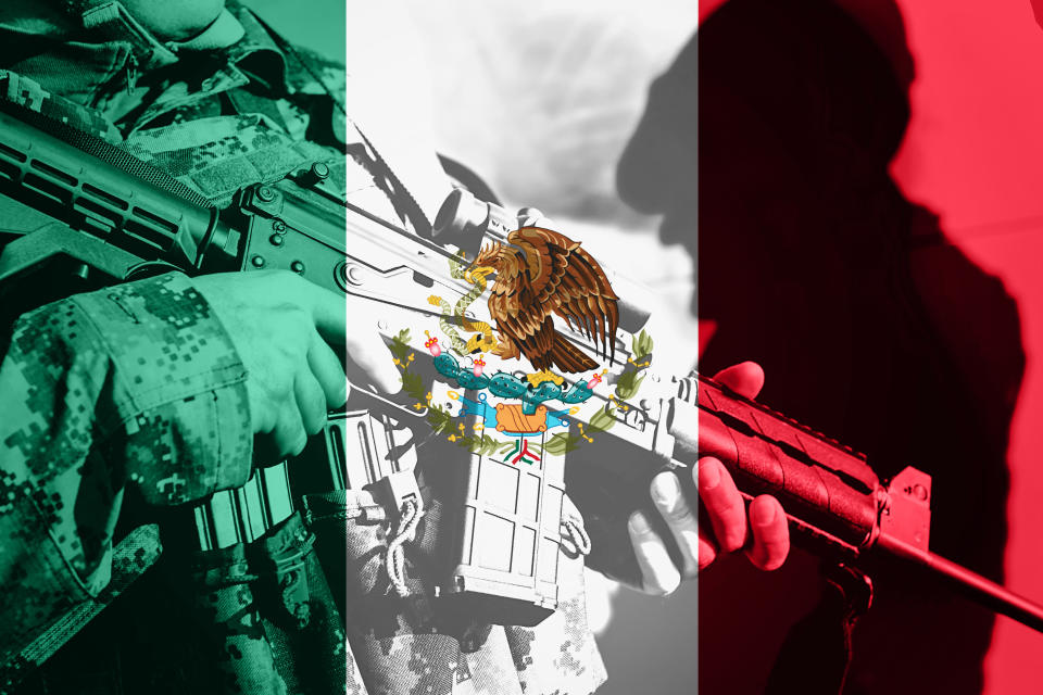 Soldier with machine gun with national flag of Mexico