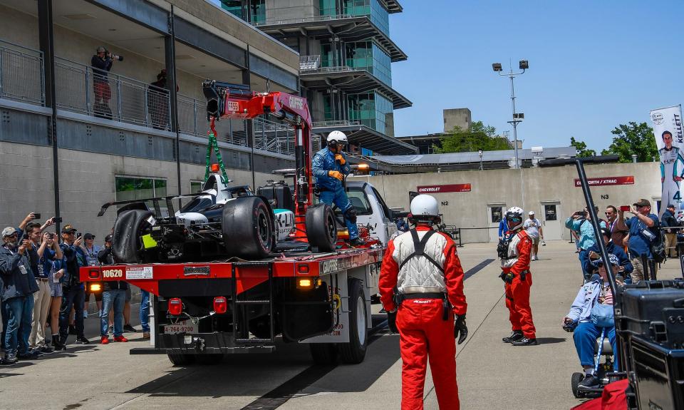 The car of A. J. Foyt Enterprises driver Dalton Kellett (4) is hauled to the team's garage Monday, May 23, 2022, during practice in preparation for the 106th running of the Indianapolis 500 at Indianapolis Motor Speedway.