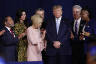 FILE - In this Jan. 3, 2020, file photo, faith leaders pray with President Donald Trump during a rally for evangelical supporters at the King Jesus International Ministry church in Miami. On Friday, March 5, 2021, The Associated Press reported on a manipulated version of this photo circulating online depicting the people praying over a golden idol of former President Donald Trump. While numerous attendees of this year’s Conservative Political Action Conference in Orlando, Florida, posed for selfies with a 6-foot-tall golden statue of Trump, the original photo was made over a year earlier. (AP Photo/Lynne Sladky, File)