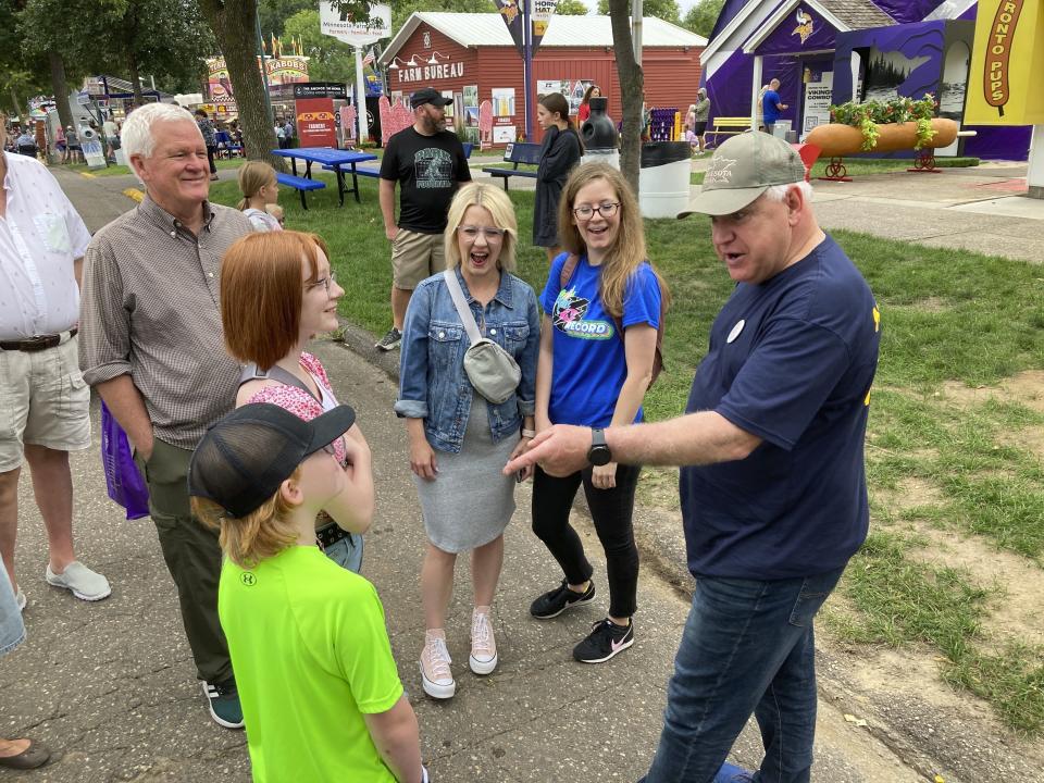 Minnesota Gov. Tim Walz chats with fairgoers on the opening day of the Minnesota State Fair on Thursday, Aug. 25, 2022, in Falcon Heights, Minn. (AP Photo/Steve Karnowski)