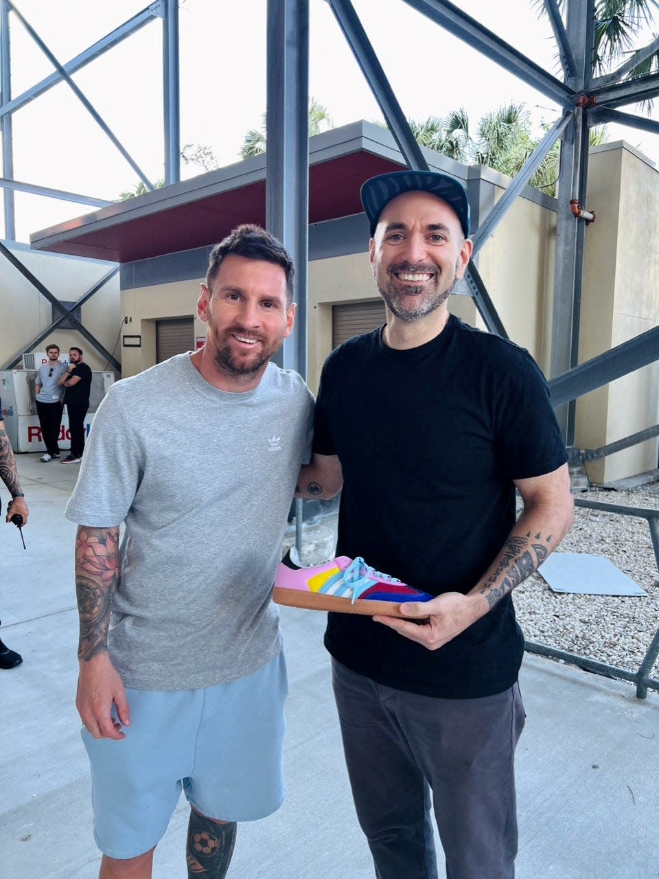 Lionel Messi fan Andrés Salerno, a sneaker customizer who designed a pair of adidas Samba shoes for Messi, holds the final product for a photo print. Messi met Salerno in Miami on Feb. 14, 2024.