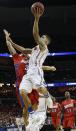 Florida guard Scottie Wilbekin (5) shoots against Dayton guard Kyle Davis (3) during the first half in a regional final game at the NCAA college basketball tournament, Saturday, March 29, 2014, in Memphis, Tenn. (AP Photo/Mark Humphrey)