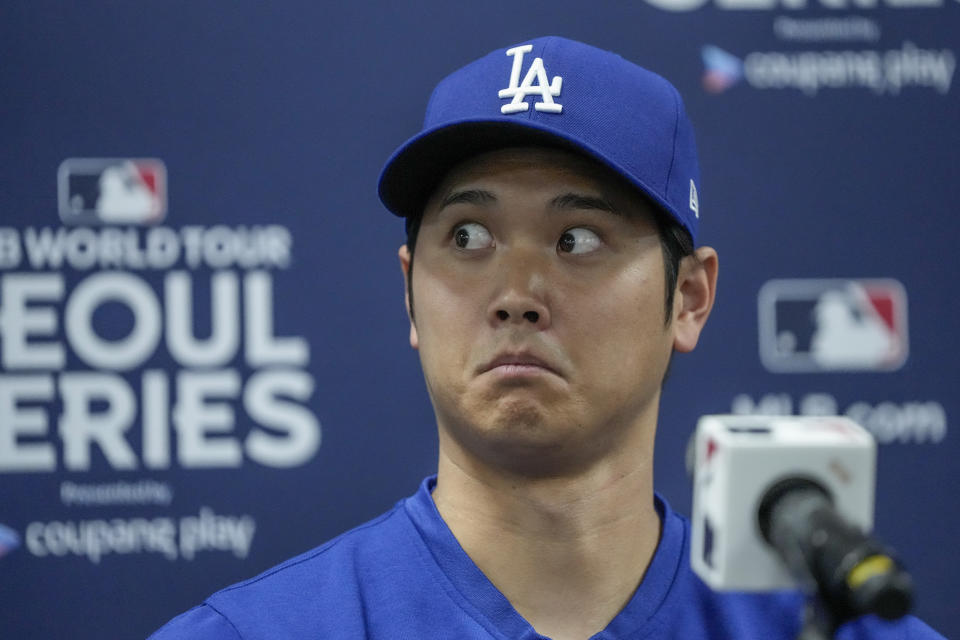 Los Angeles Dodgers' Shohei Ohtani reacts during a news conference ahead of a baseball workout at the Gocheok Sky Dome in Seoul, South Korea, Saturday, March 16, 2024. (AP Photo/Lee Jin-man)