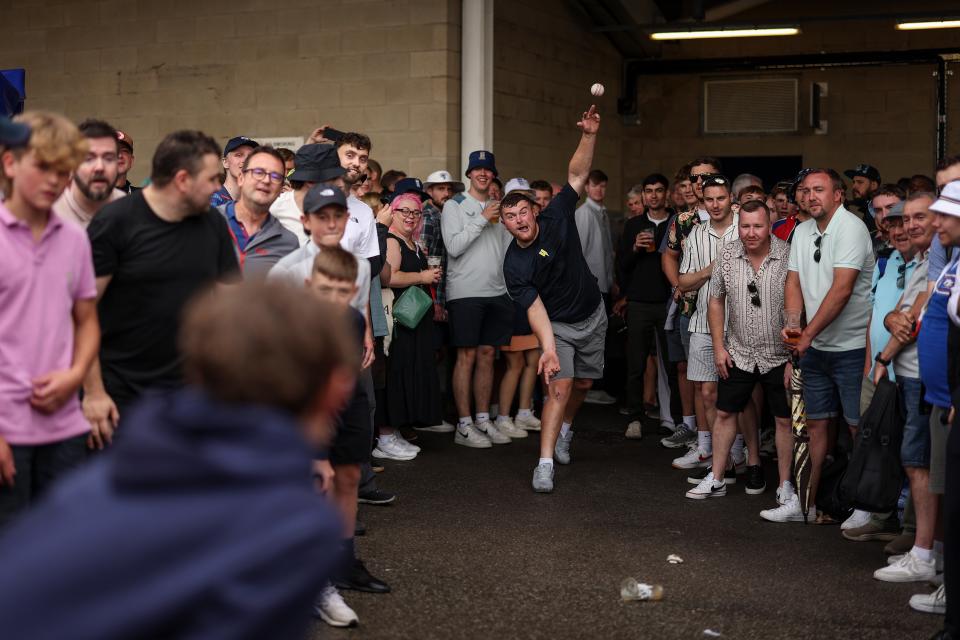 Spectators play a game of cricket under the Western Terrace (Getty Images)