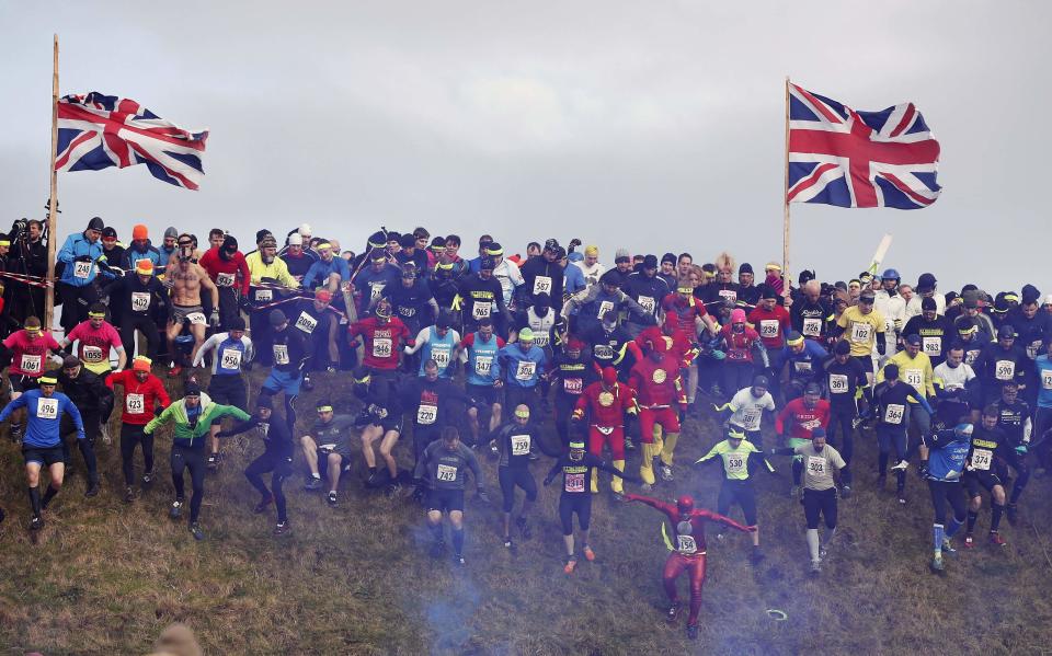 Competitors cross the start line during the Tough Guy event in Perton, central England