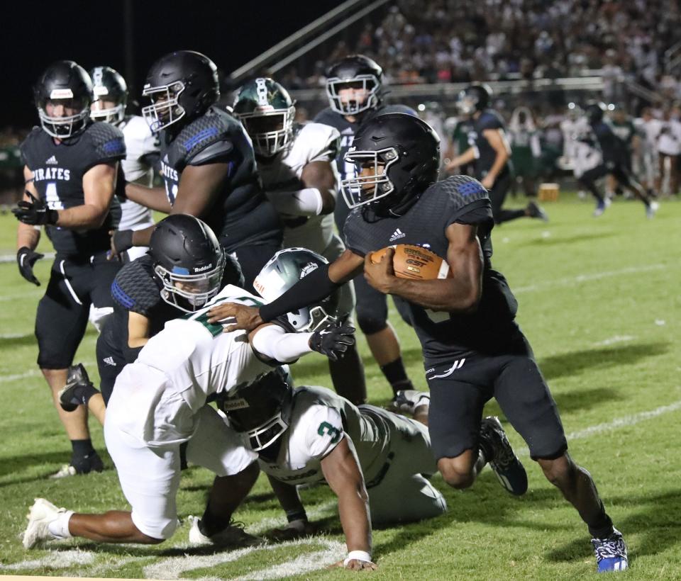 Matanzas High's Dakwon Evans #3 pushes away a Flagler Palm Coast High player, Friday September 15, 2023 for a long run..