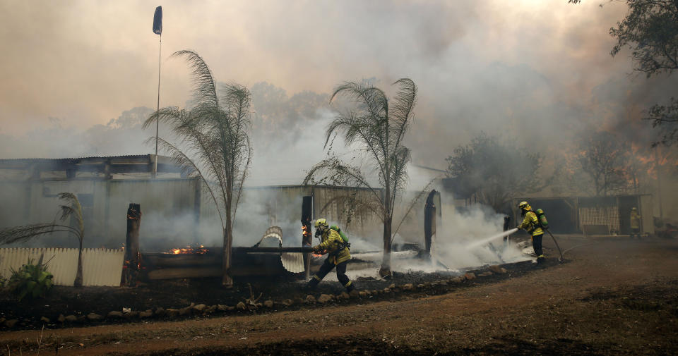 Firefighters save a house on Bullocky Way, Possum Brush, south of Taree in the Mid North Coast region of NSW.