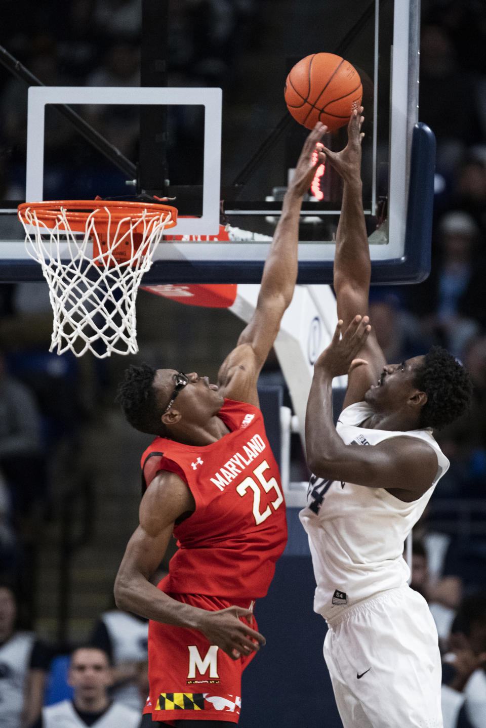 Penn State forward Mike Watkins (24) shoots over Maryland forward Jalen Smith (25) in the first half of an NCAA college basketball game in State College, Pa., on Tuesday, Dec. 10, 2019. (AP Photo/Barry Reeger)